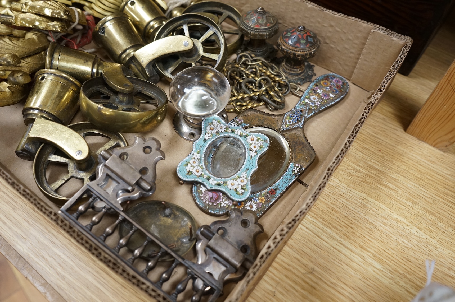 A brush grained tin trunk containing brass furniture mounts and fittings and a micromosaic miniature photo frame and hand mirror, trunk 47cm wide (a.f.)